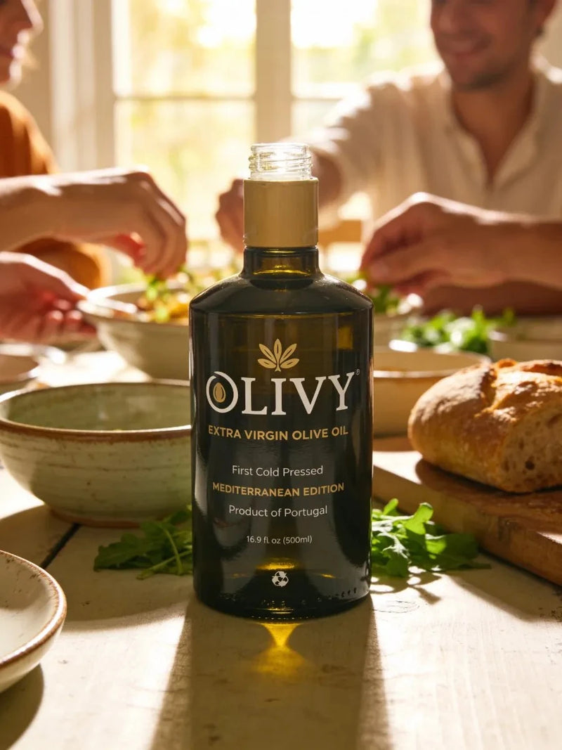 Bottle of Olivy Extra Virgin Olive Oil on a table with people eating in the background