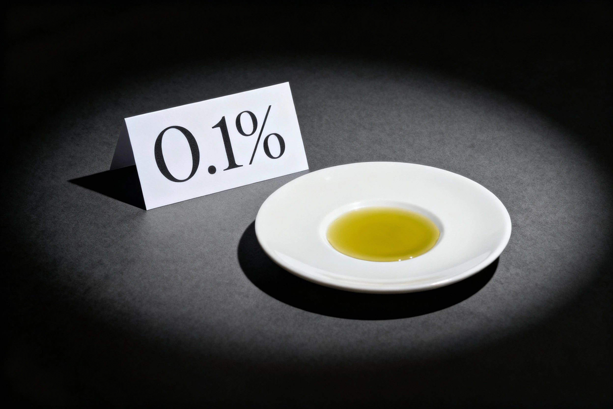 Small amount of liquid on a white plate with a sign indicating '0.1%'.